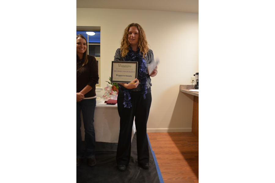 Habitat for Humanity's Director holds the award.