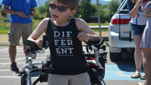 Child with T-shirt that says "Different Is the New Normal"