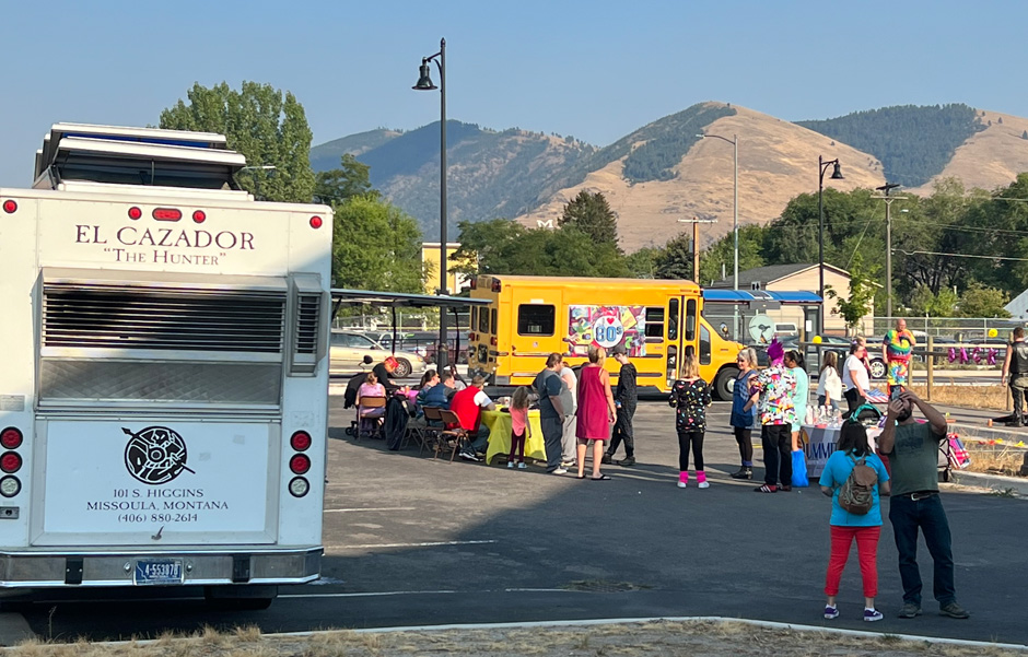 The El Cazador food truck is parked at the new Summit building site where a crowd enjoys the Summit 80's Party