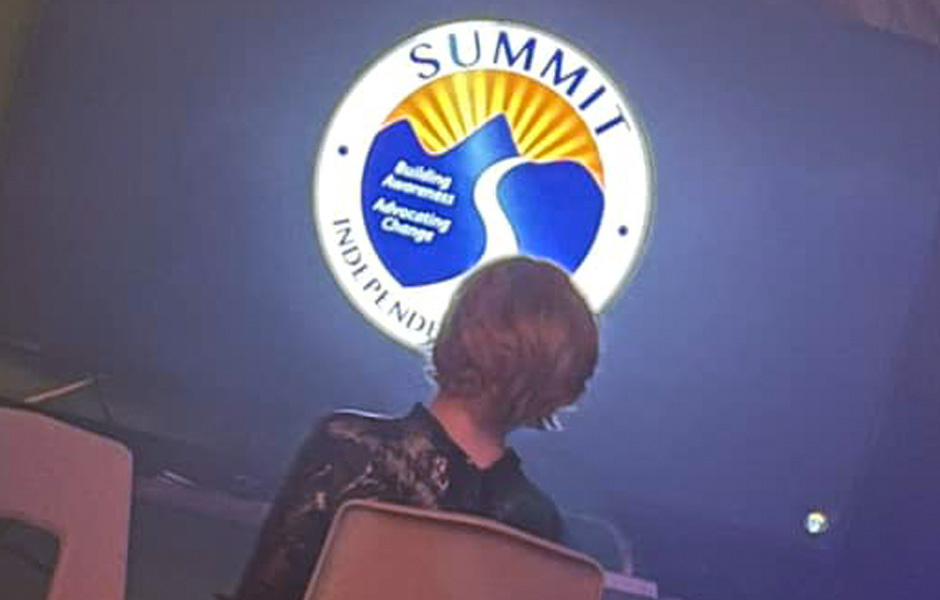 Little Man watches a video showcasing the Summit logo