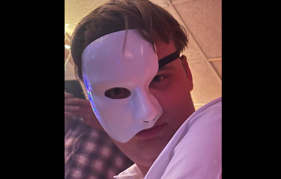 Ethan in his Phantom of the Opera mask poses for a picture
